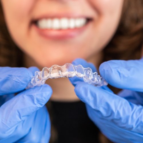 Orthodontic retainer being held during post-treatment smile retention care at Boyd Orthodontics in Glen Allen, VA 23059