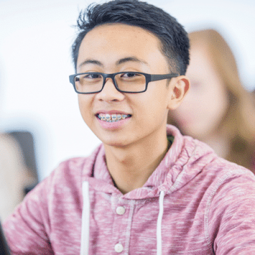 Teen patient smiling with braces during orthodontic treatment at Boyd Orthodontics in Glen Allen, VA 23059